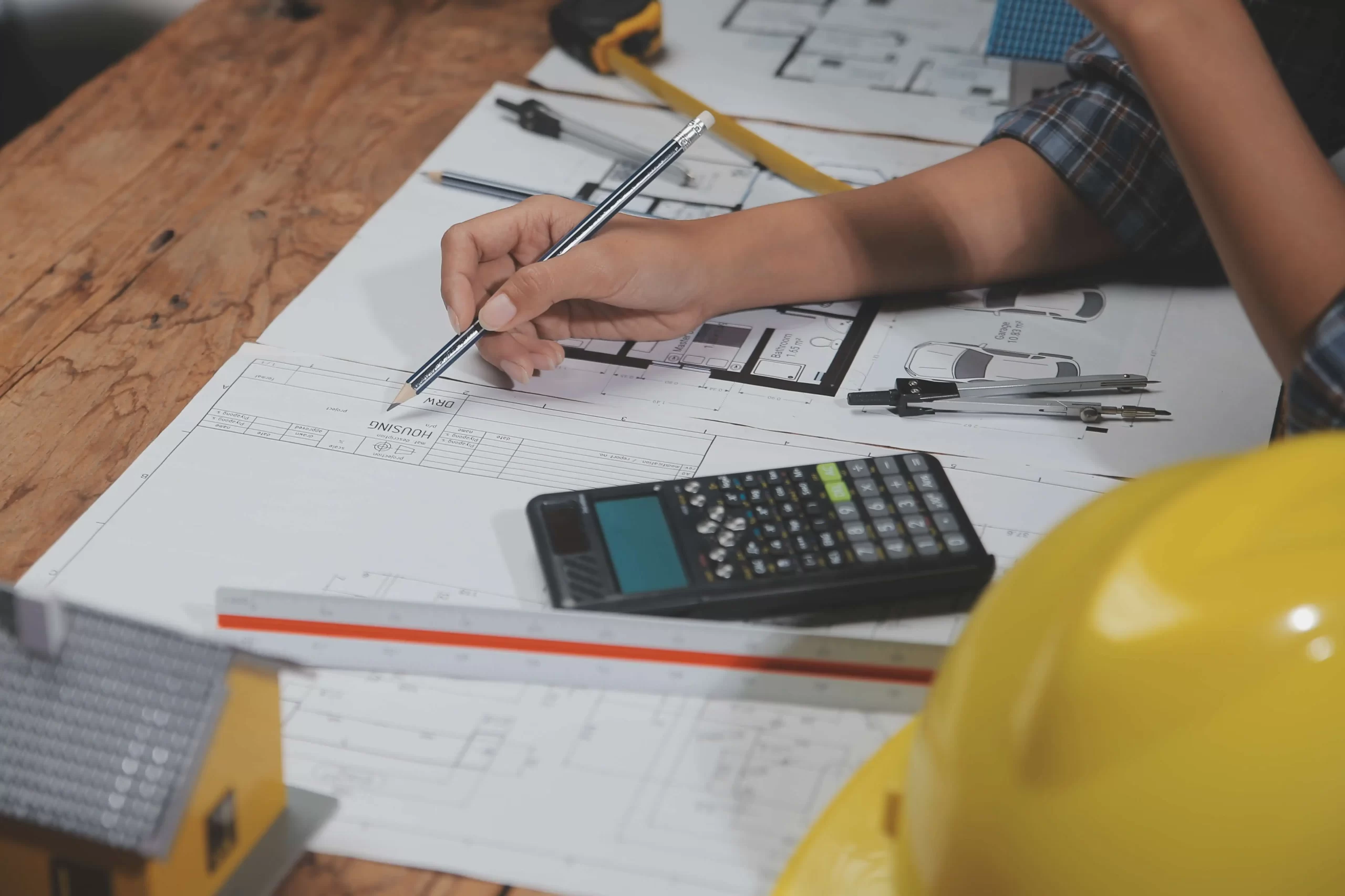 team-multiethnic-architects-working-construction-plans-meeting-room-engineers-discussing-project-office-mature-businessman-woman-standing-around-table-working-blueprint (1)